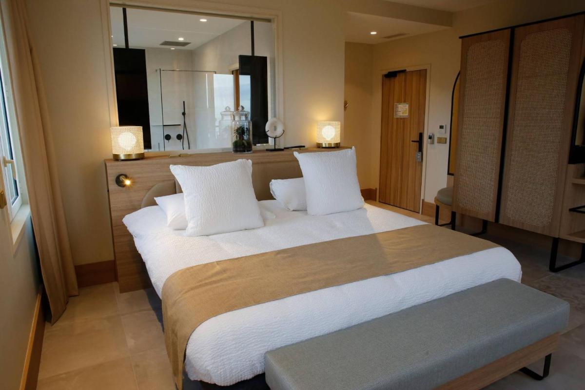 Un ou plusieurs lits dans un hébergement de l'établissement Splendid Hôtel & Spa