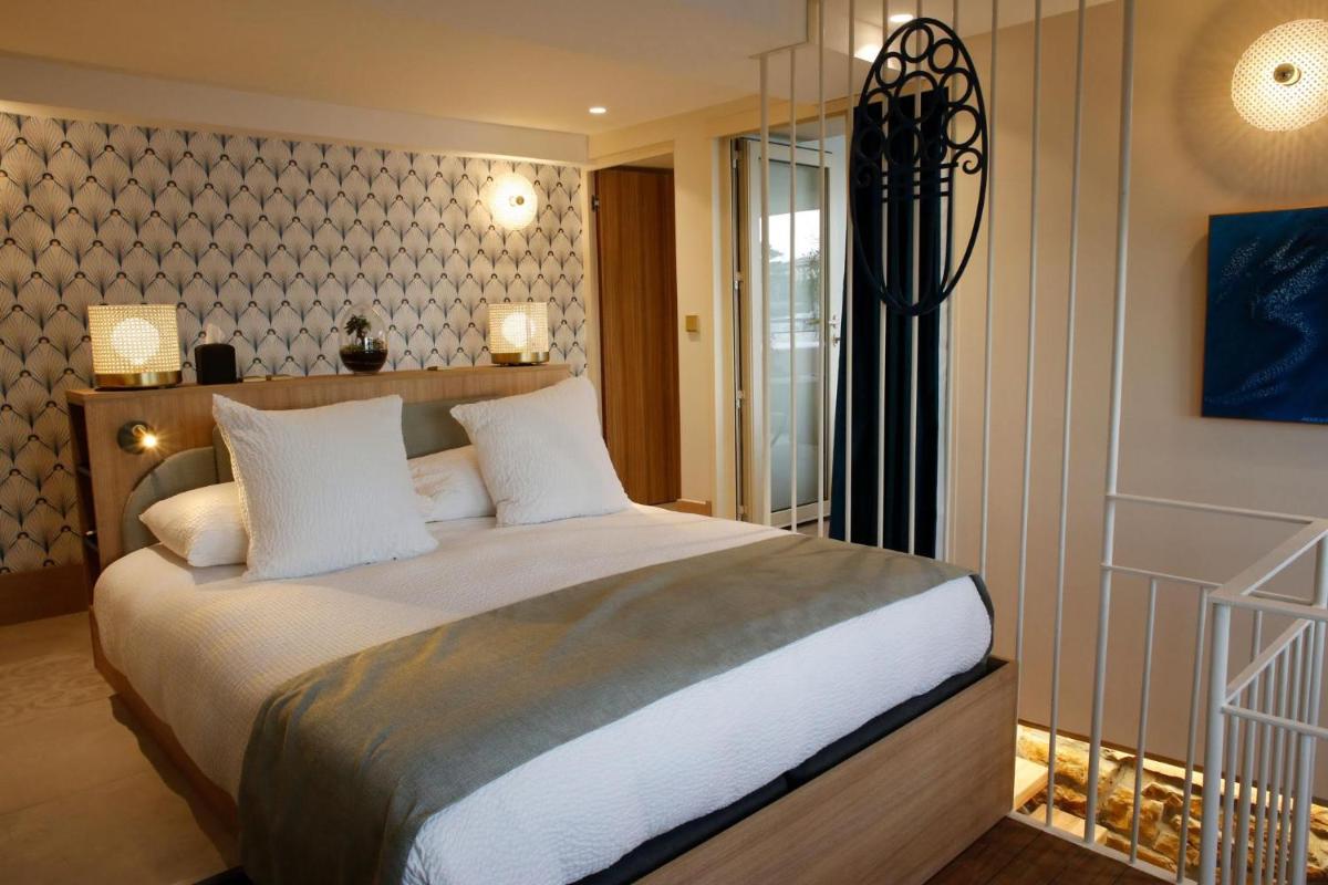 Un ou plusieurs lits dans un hébergement de l'établissement Splendid Hôtel & Spa