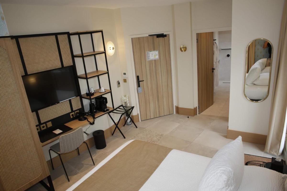 Télévision ou salle de divertissement dans l'établissement Splendid Hôtel & Spa