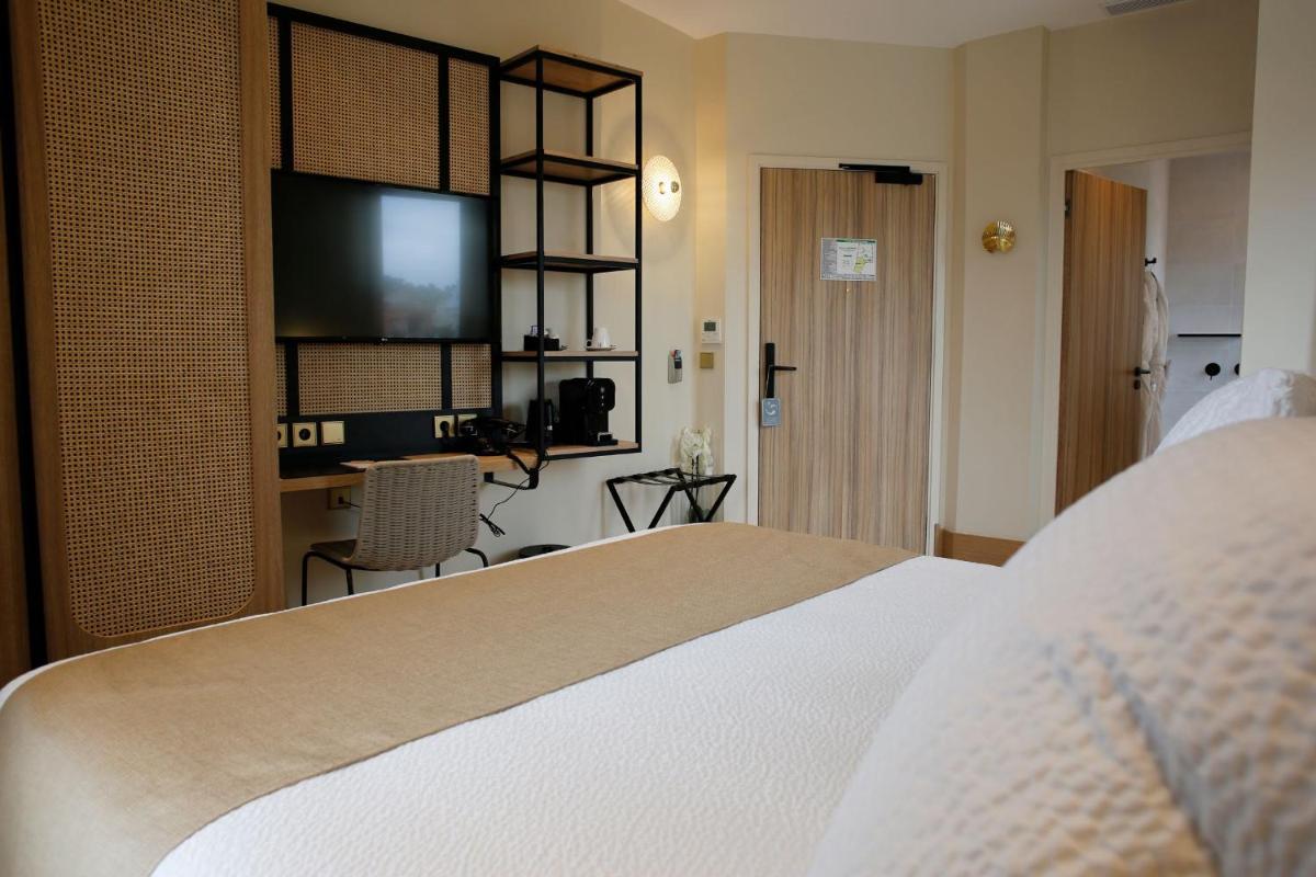 Un ou plusieurs lits dans un hébergement de l'établissement Splendid Hôtel & Spa
