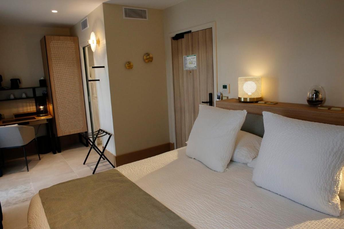 Un ou plusieurs lits dans un hébergement de l'établissement Splendid Hôtel & Spa