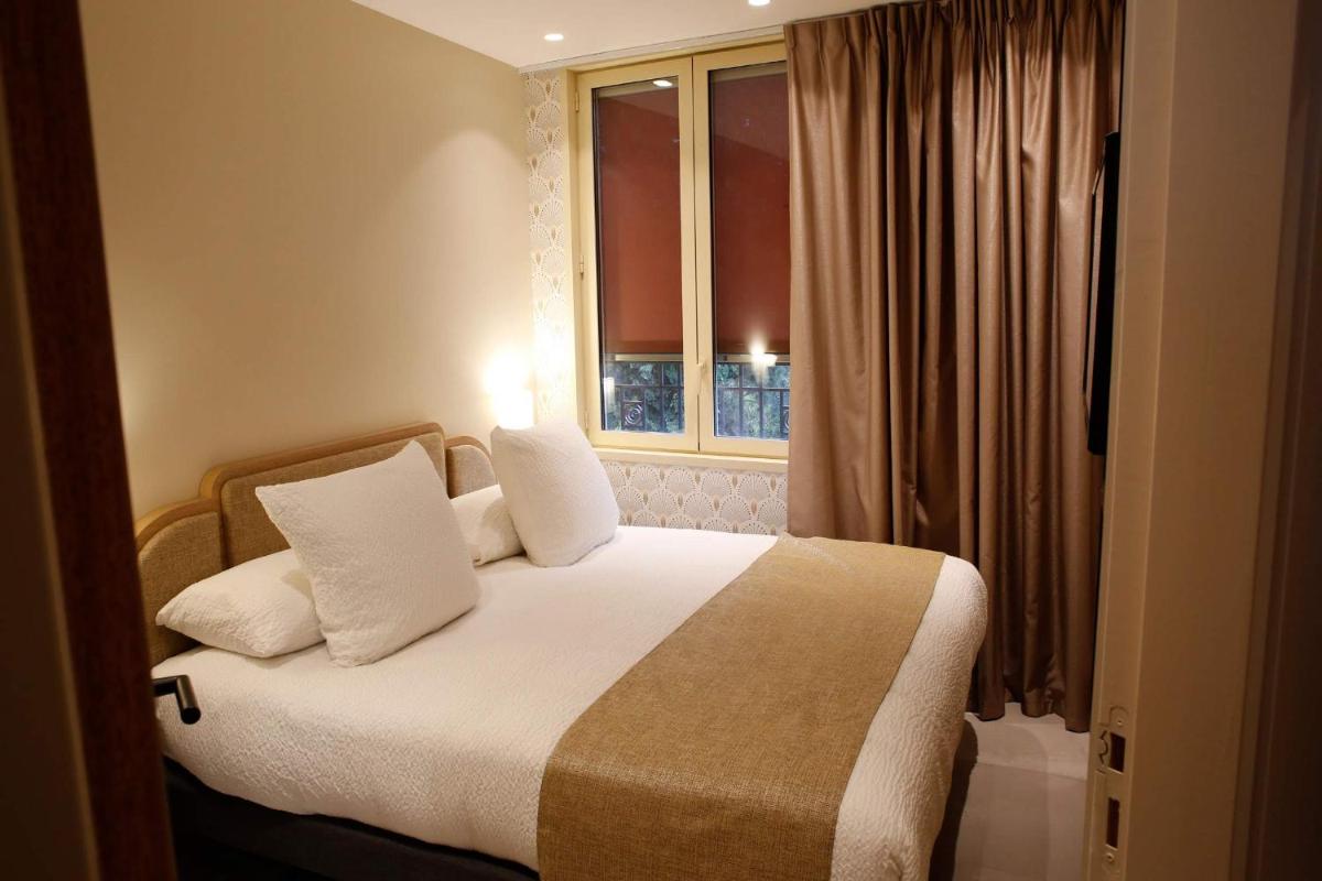 Un ou plusieurs lits dans un hébergement de l'établissement Splendid Hôtel & Spa