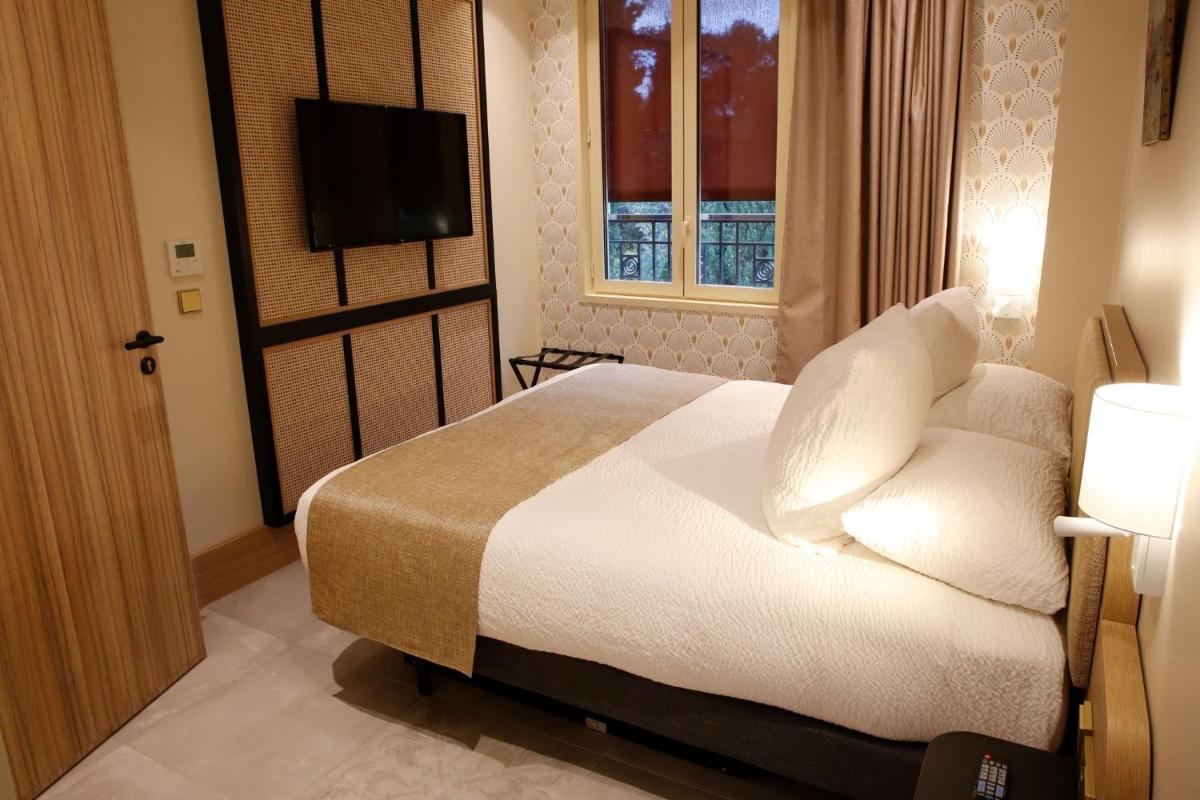 Un ou plusieurs lits dans un hébergement de l'établissement Splendid Hôtel & Spa