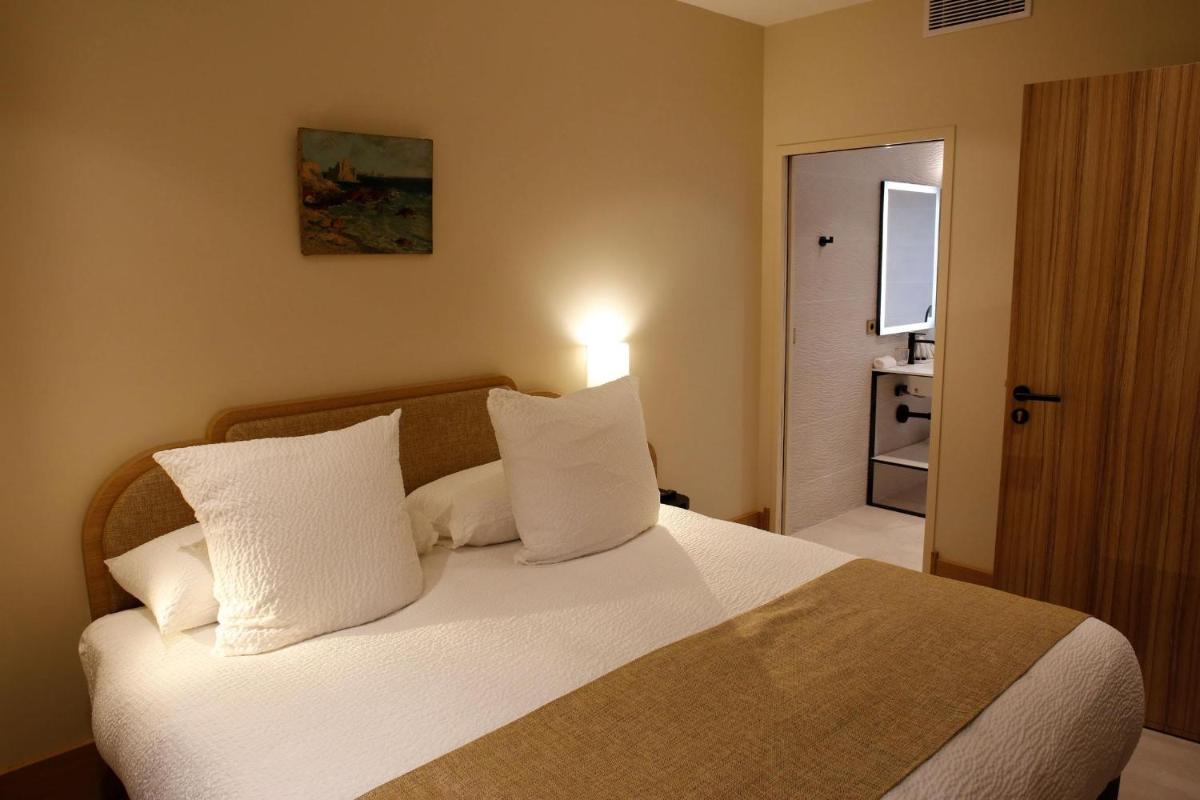 Un ou plusieurs lits dans un hébergement de l'établissement Splendid Hôtel & Spa