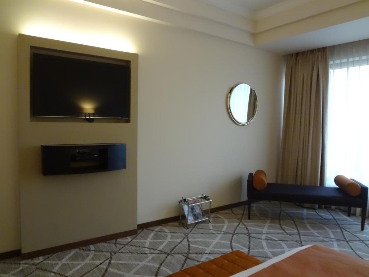 a living room with a flat screen tv on a wall at Hotel Marine Plaza in Mumbai
