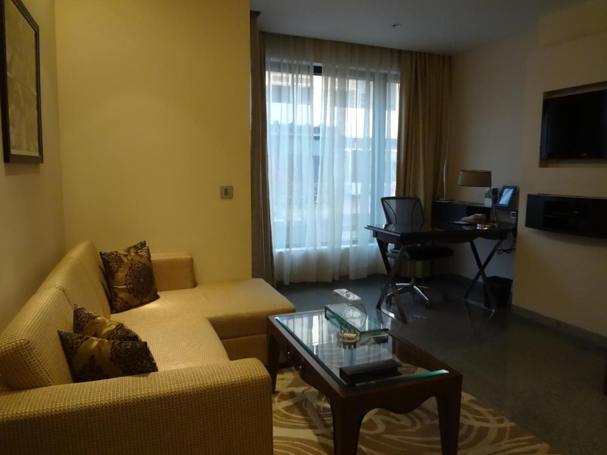 a living room with a couch and a table at Hotel Marine Plaza in Mumbai