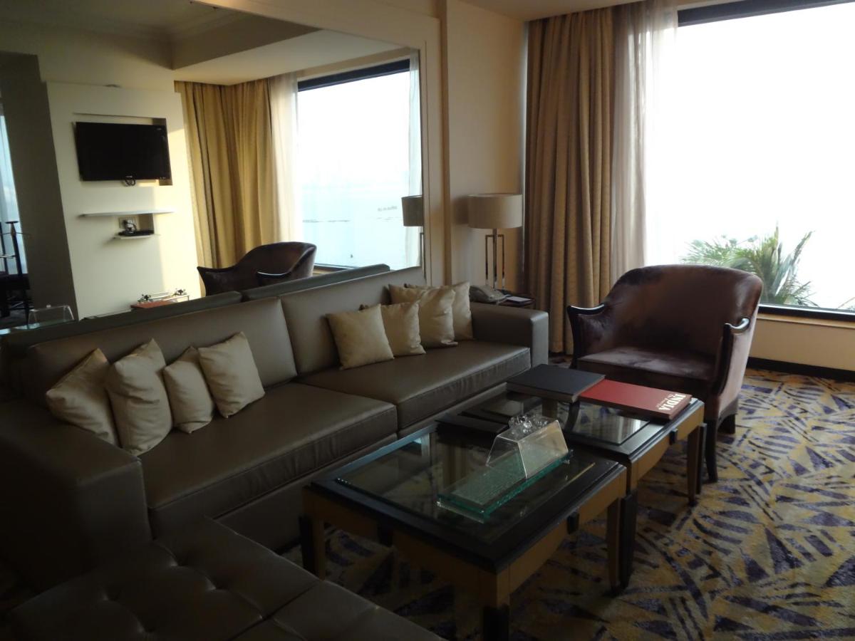 a living room with a couch and a coffee table at Hotel Marine Plaza in Mumbai