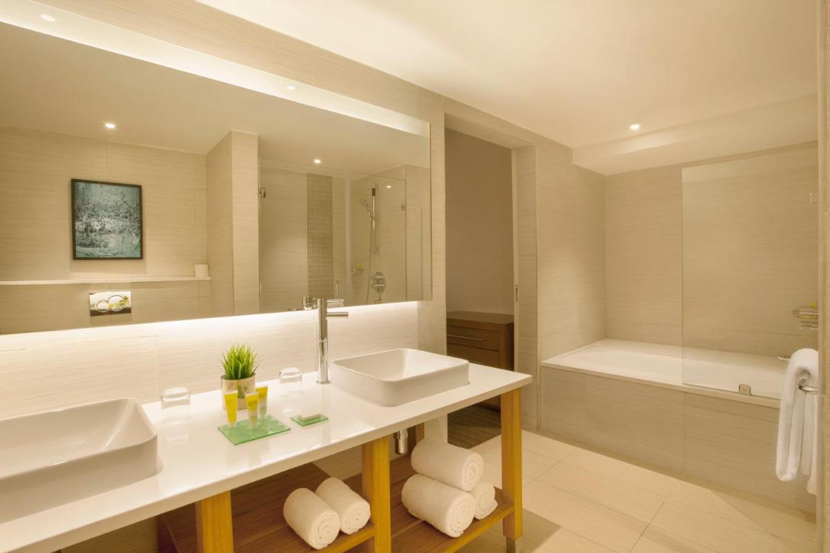 a bathroom with a sink and a bath tub at Hyatt Place Hyderabad Banjara Hills in Hyderabad a bathroom with a sink and a bath tub at Hyatt Place Hyderabad Banjara Hills in Hyderabad