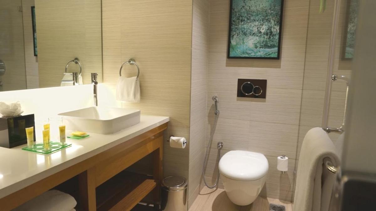 a bathroom with a sink and a toilet and a shower at Hyatt Place Hyderabad Banjara Hills in Hyderabad
