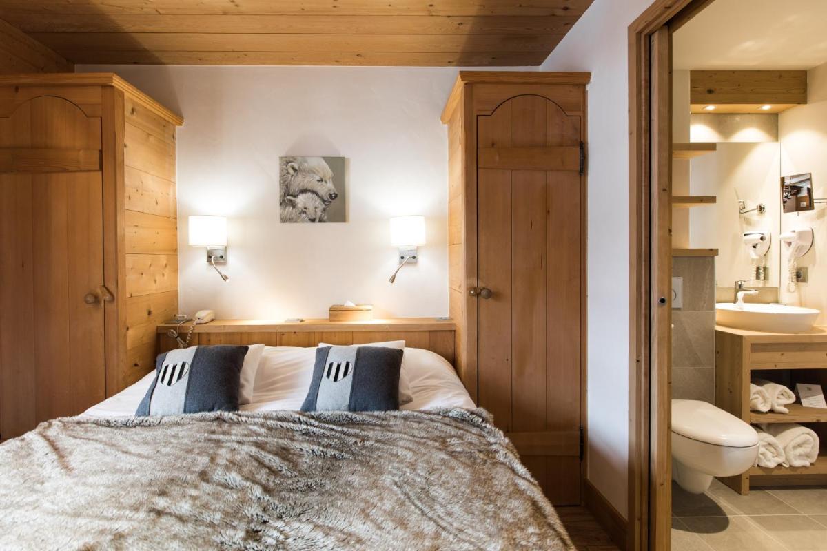Un ou plusieurs lits dans un hébergement de l'établissement Les Chalets de La Griyotire