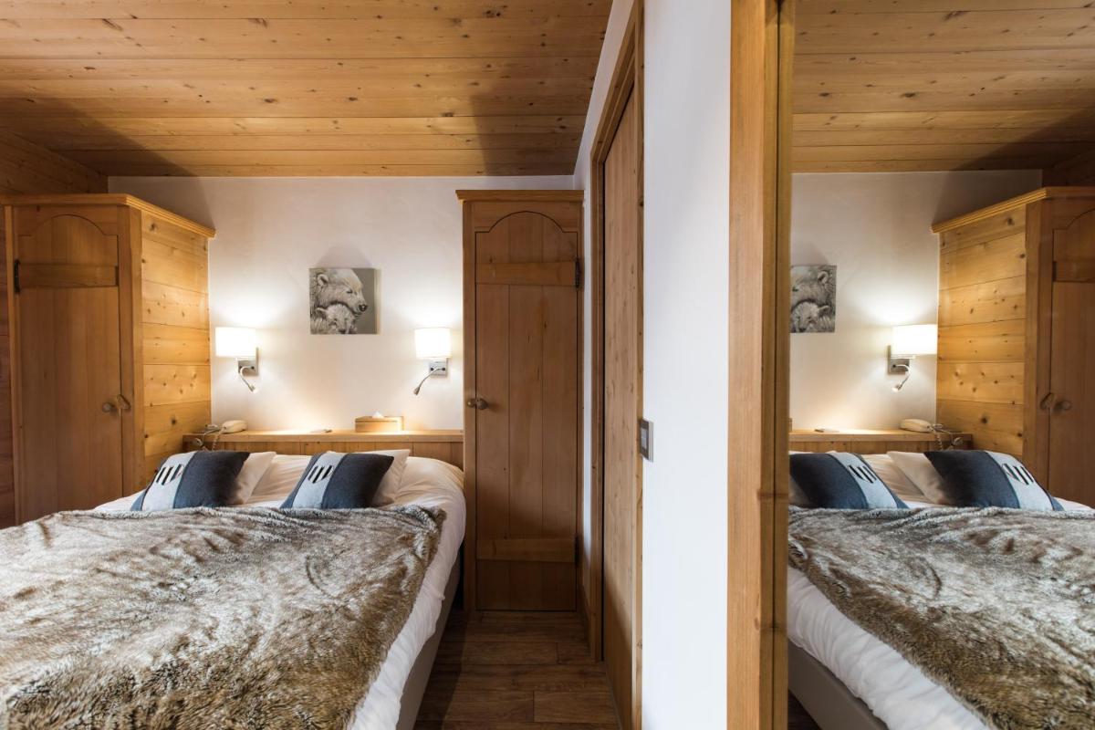 Un ou plusieurs lits dans un hébergement de l'établissement Les Chalets de La Griyotire