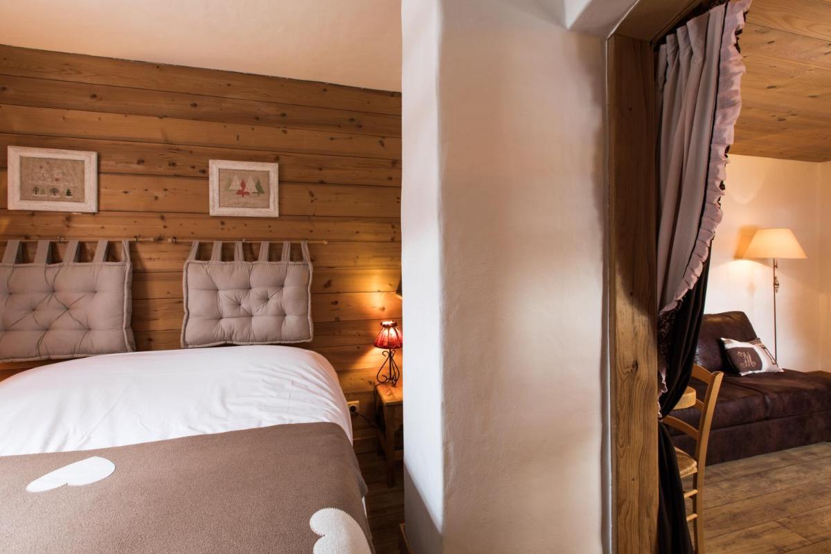 Un ou plusieurs lits dans un hébergement de l'établissement Les Chalets de La Griyotire