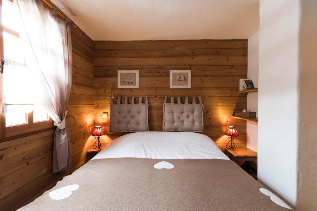 Un ou plusieurs lits dans un hébergement de l'établissement Les Chalets de La Griyotire