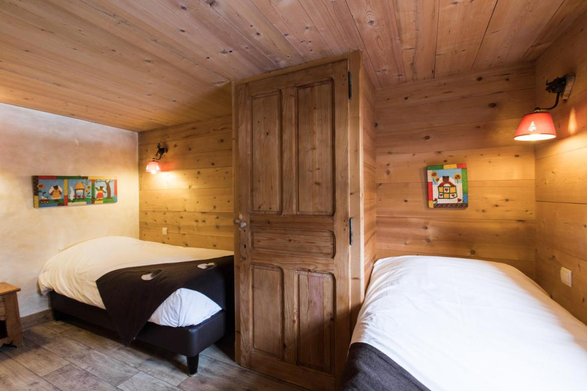 Un ou plusieurs lits dans un hébergement de l'établissement Les Chalets de La Griyotire