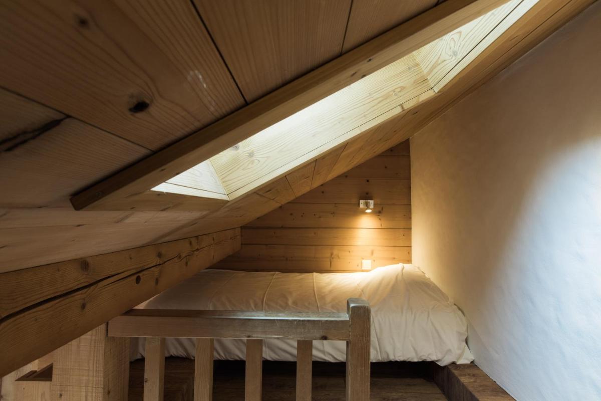 Un ou plusieurs lits dans un hébergement de l'établissement Les Chalets de La Griyotire