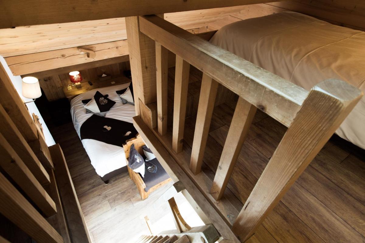 Un ou plusieurs lits dans un hébergement de l'établissement Les Chalets de La Griyotire