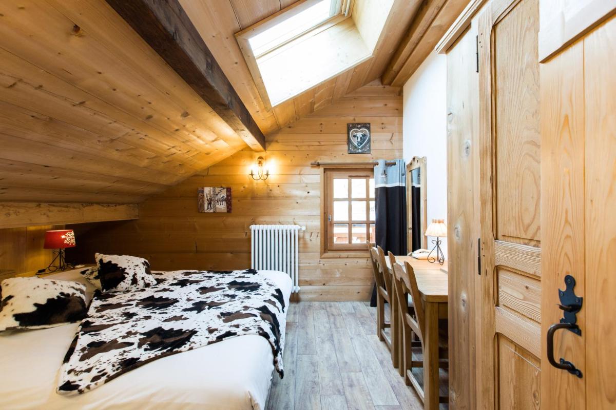 Un ou plusieurs lits dans un hébergement de l'établissement Les Chalets de La Griyotire