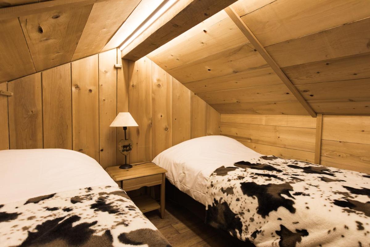 Un ou plusieurs lits dans un hébergement de l'établissement Les Chalets de La Griyotire