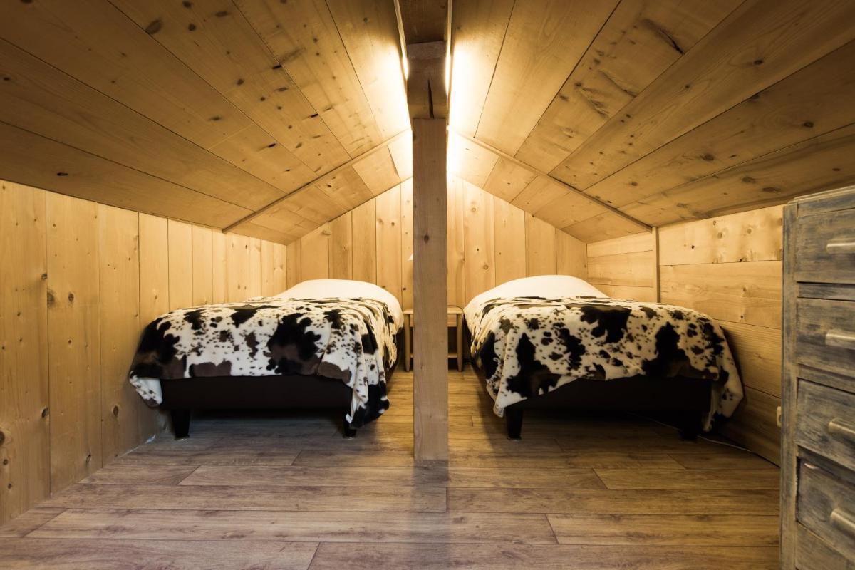 Un ou plusieurs lits dans un hébergement de l'établissement Les Chalets de La Griyotire