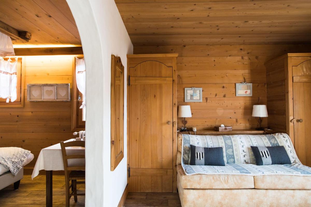 Un ou plusieurs lits dans un hébergement de l'établissement Les Chalets de La Griyotire