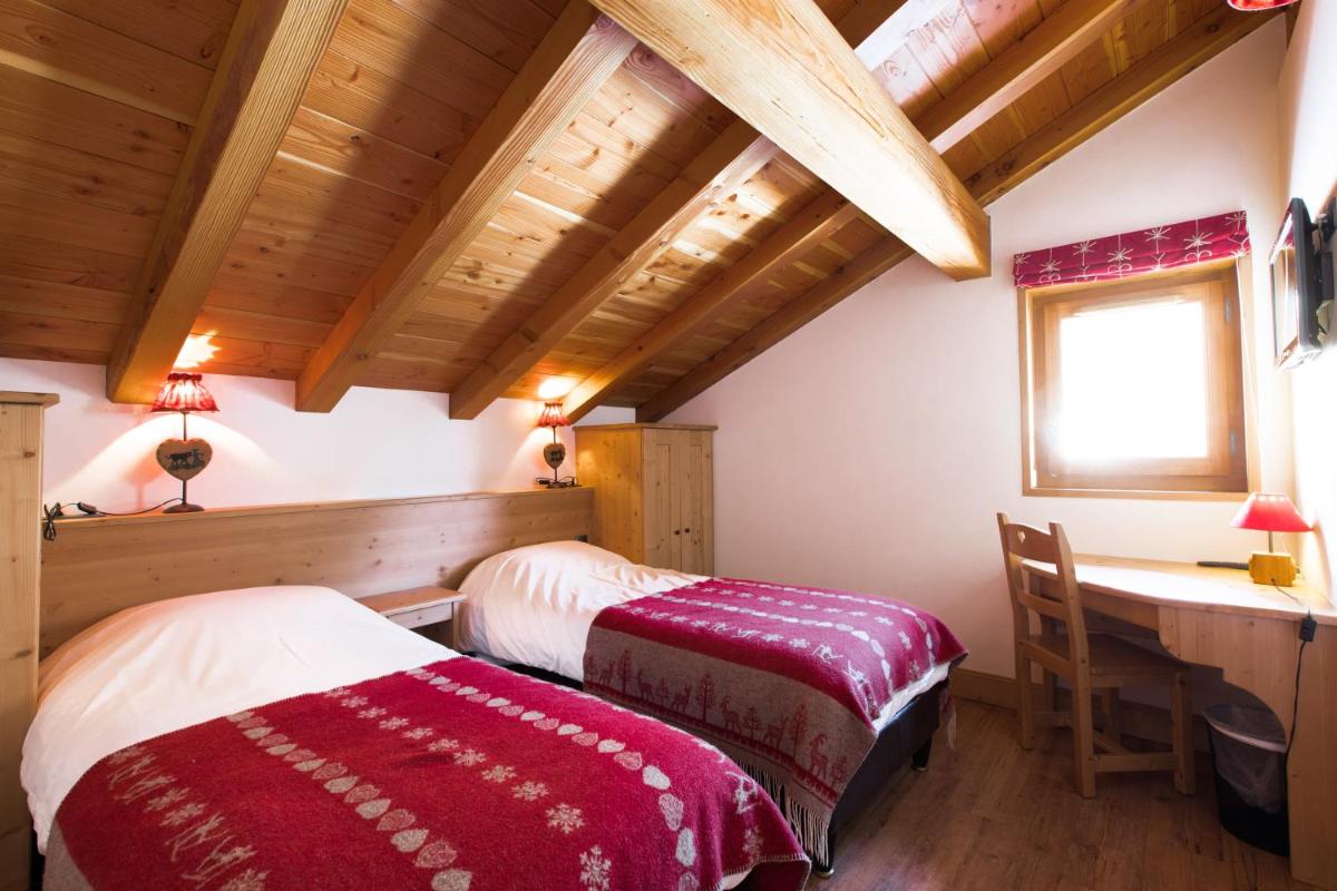 Un ou plusieurs lits dans un hébergement de l'établissement Les Chalets de La Griyotire