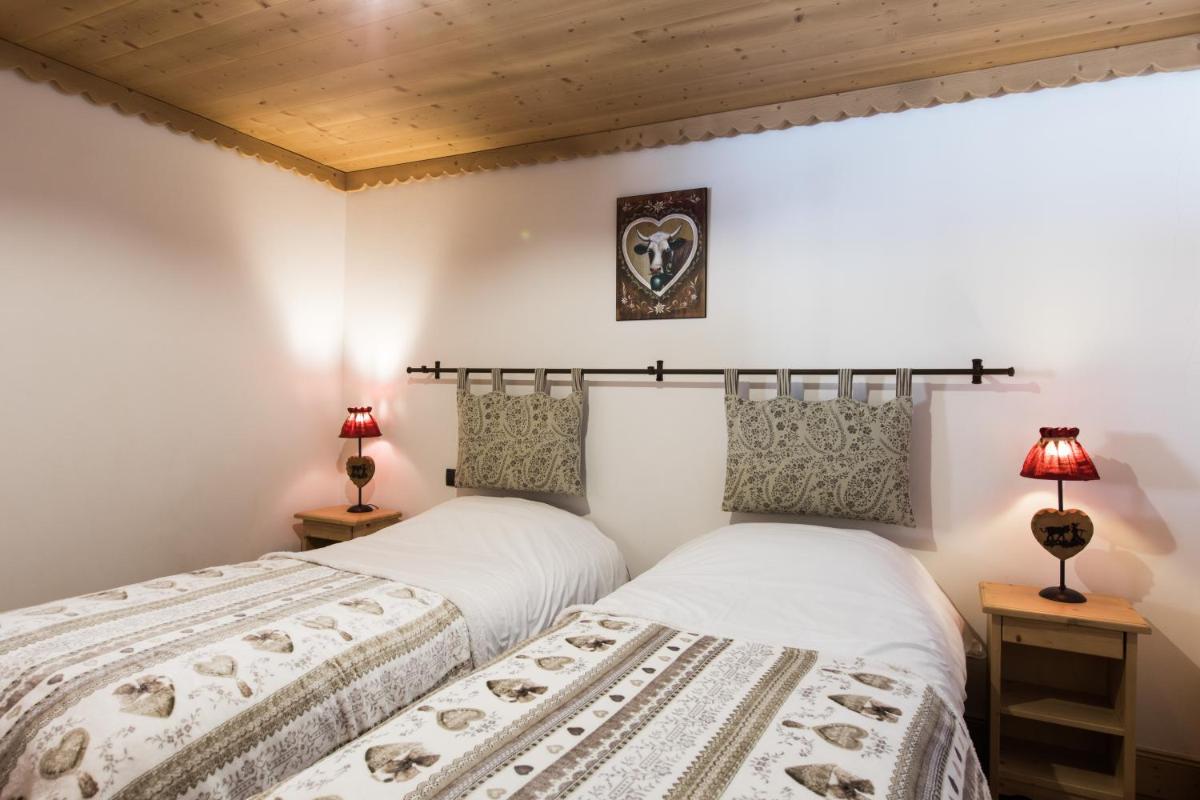 Un ou plusieurs lits dans un hébergement de l'établissement Les Chalets de La Griyotire