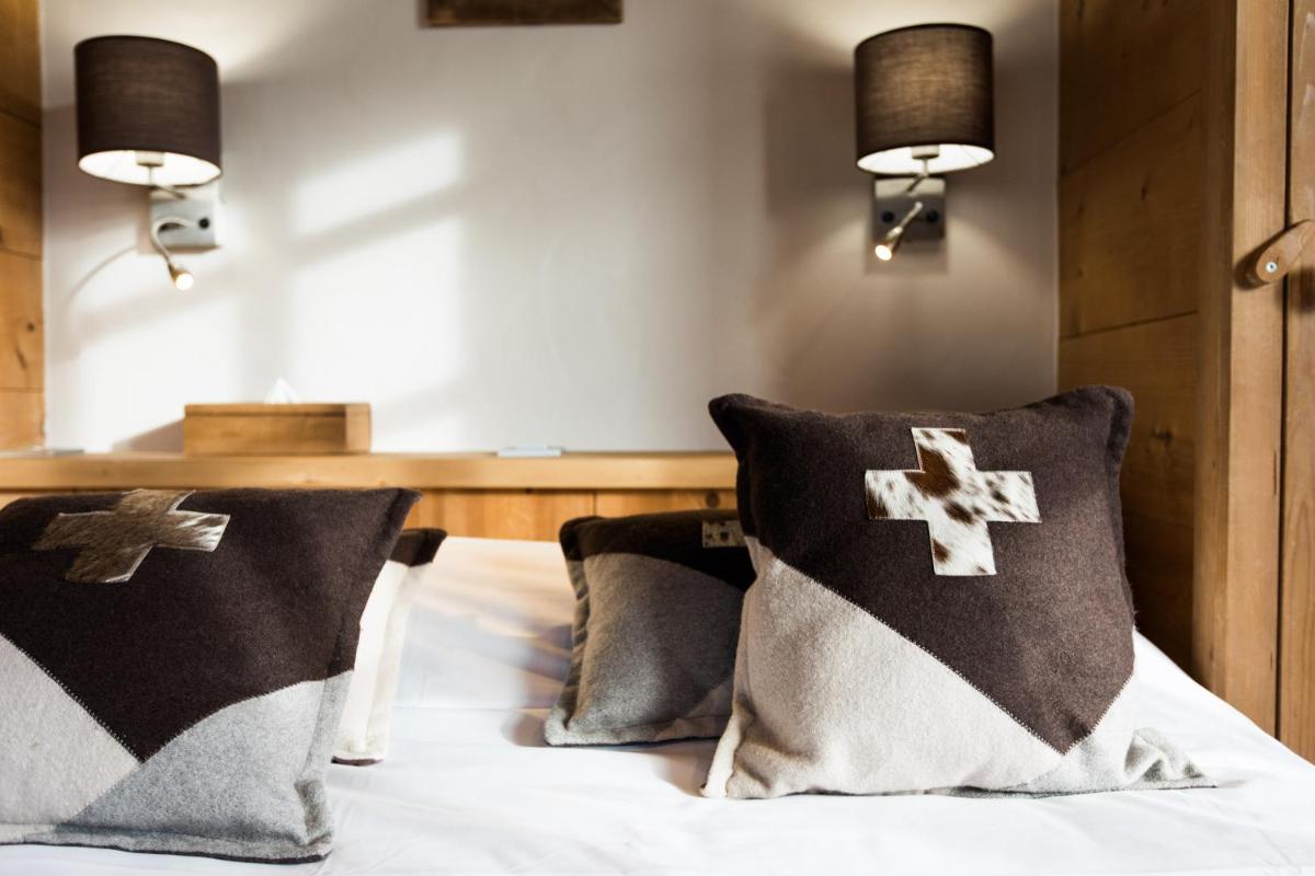 Un ou plusieurs lits dans un hébergement de l'établissement Les Chalets de La Griyotire