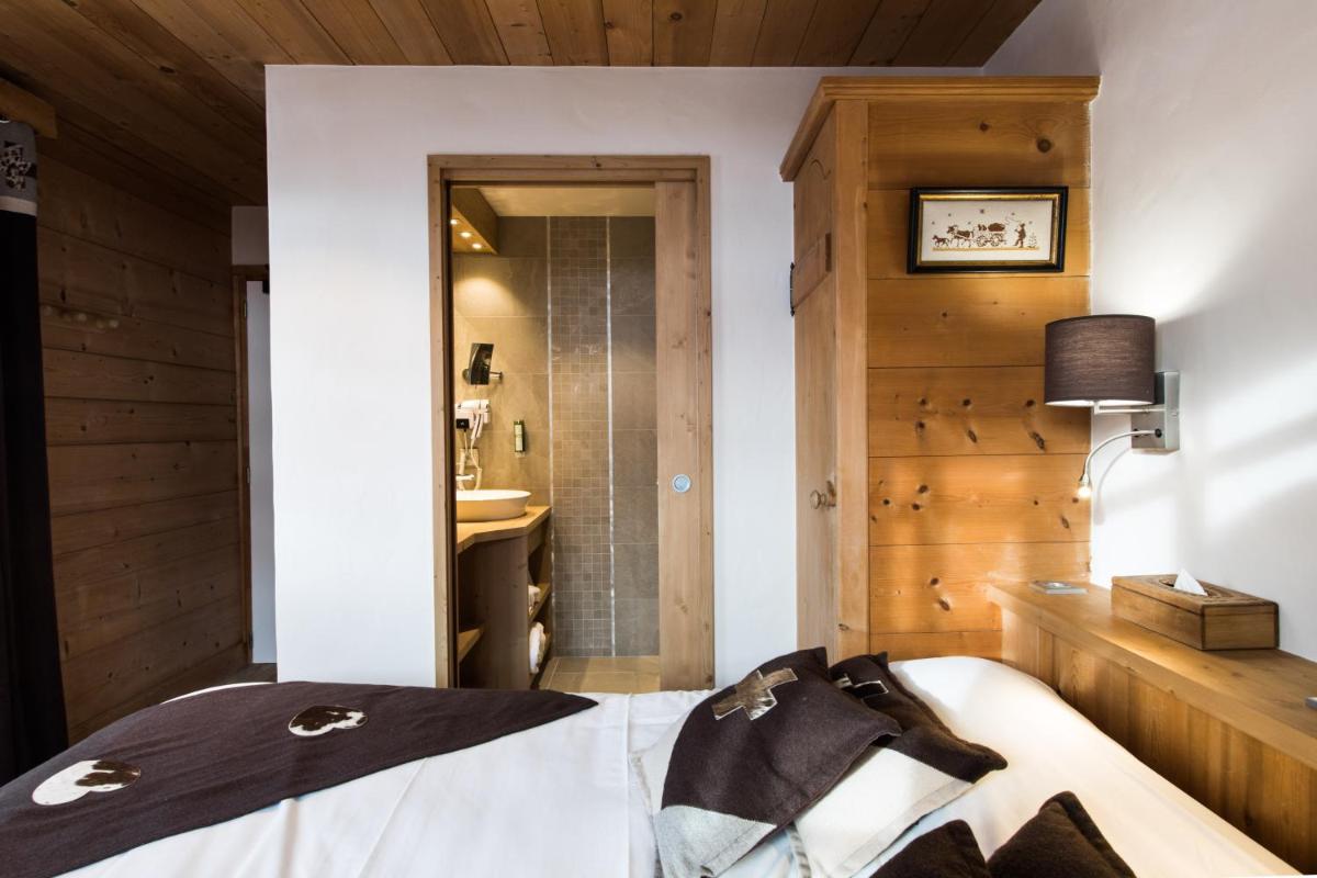 Un ou plusieurs lits dans un hébergement de l'établissement Les Chalets de La Griyotire