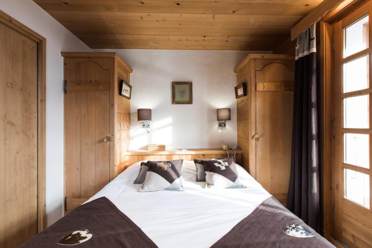 Un ou plusieurs lits dans un hébergement de l'établissement Les Chalets de La Griyotire