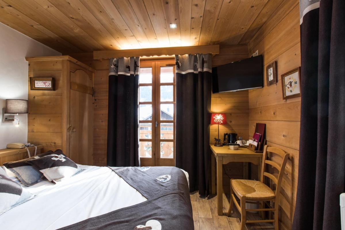 Un ou plusieurs lits dans un hébergement de l'établissement Les Chalets de La Griyotire