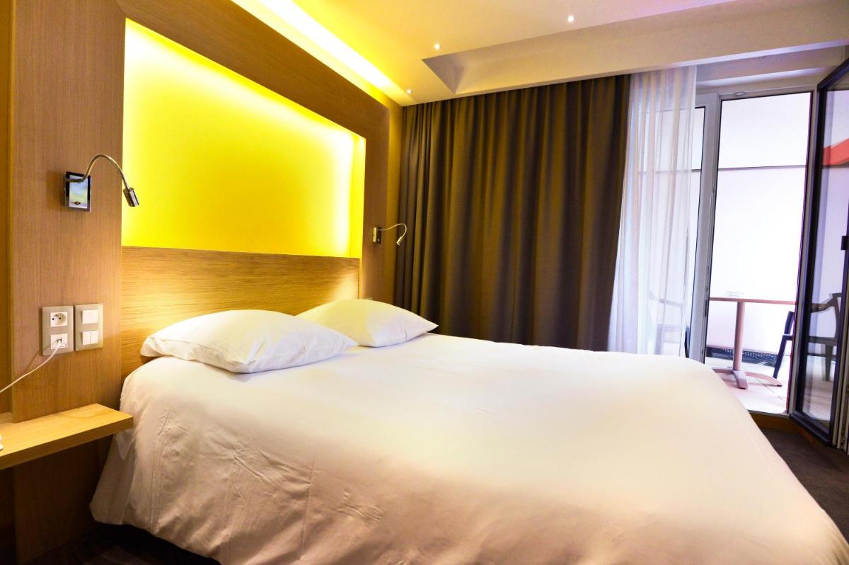 Un ou plusieurs lits dans un hébergement de l'établissement Au Soleil, Hôtel Restaurant & Spa