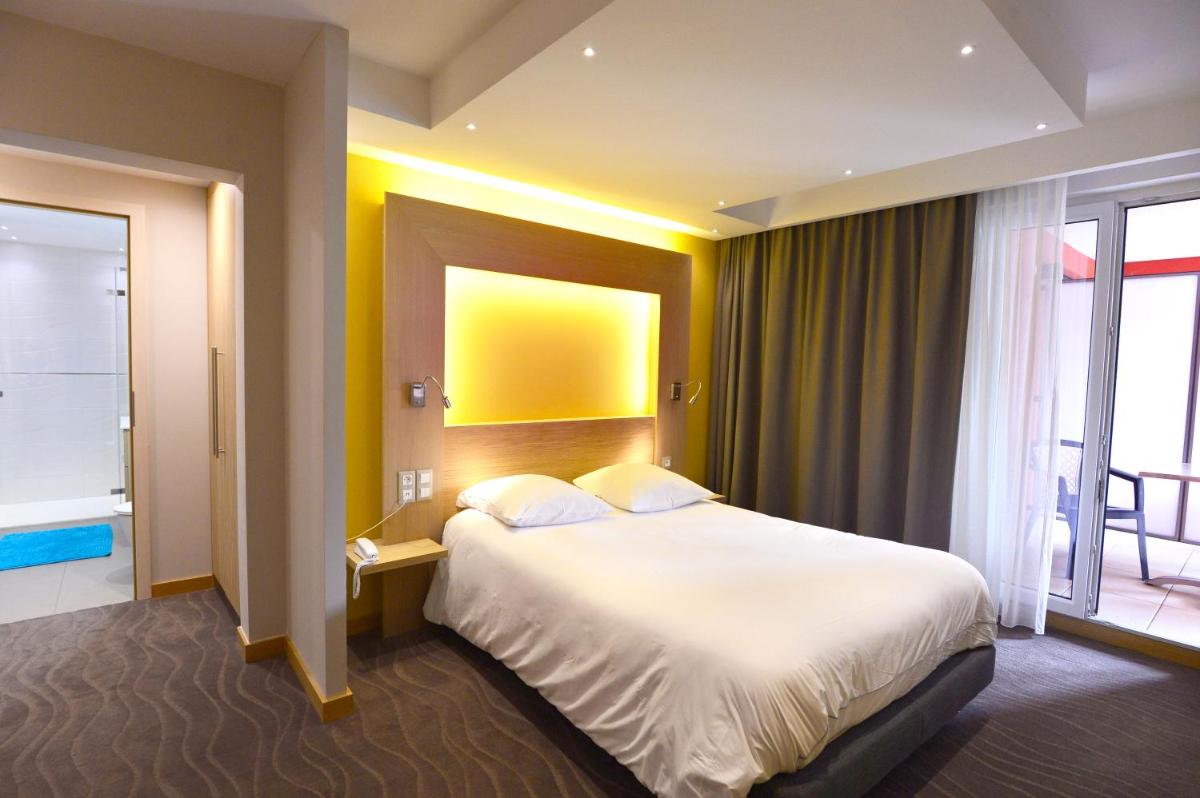 Un ou plusieurs lits dans un hébergement de l'établissement Au Soleil, Hôtel Restaurant & Spa