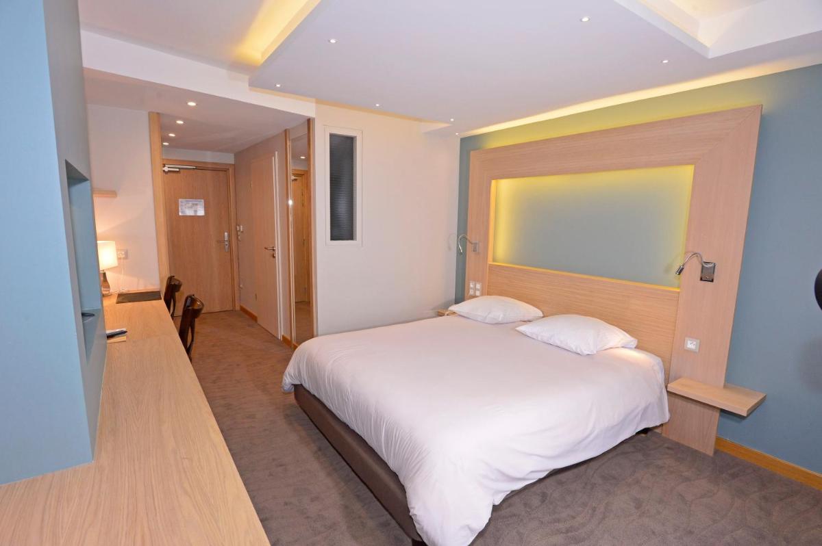 Un ou plusieurs lits dans un hébergement de l'établissement Au Soleil, Hôtel Restaurant & Spa