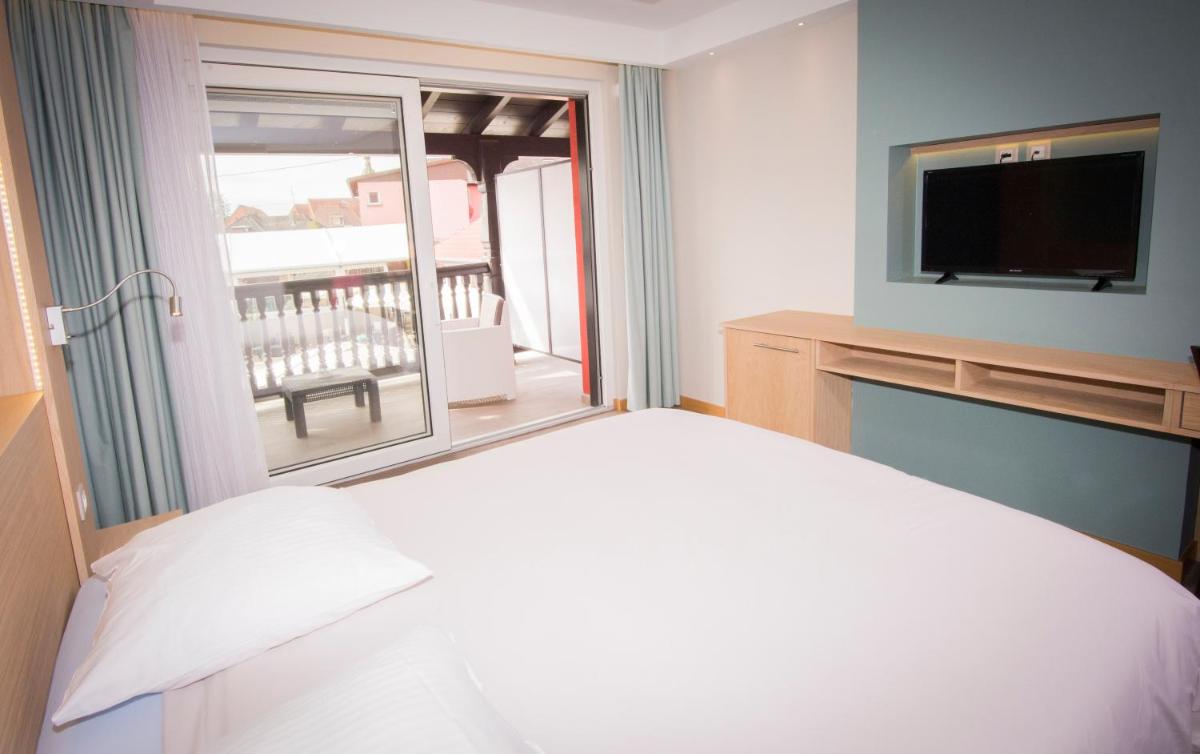 Un ou plusieurs lits dans un hébergement de l'établissement Au Soleil, Hôtel Restaurant & Spa