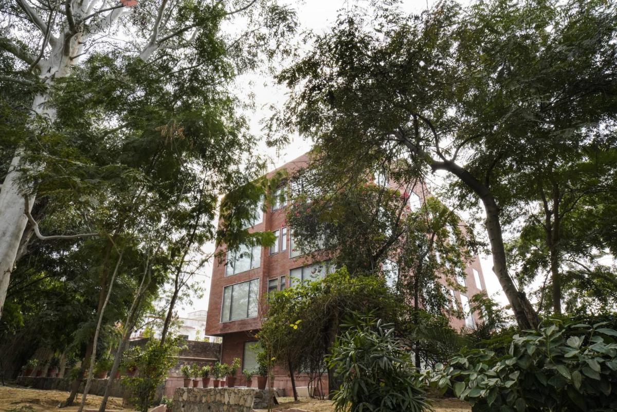 a building with trees in front of it at Brij Nest, Jaipur - An All Suite Boutique Hotel in Jaipur