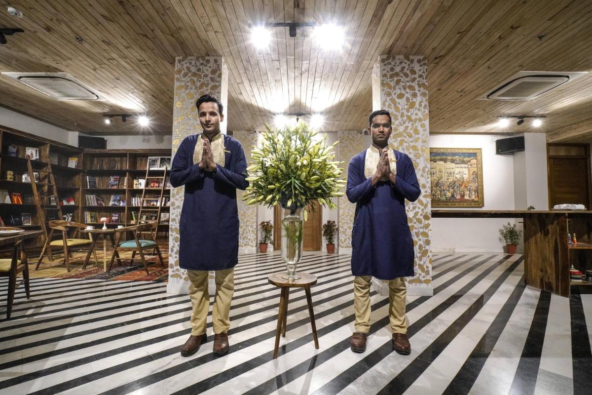 two men standing in a room with their arms crossed at Brij Nest, Jaipur - An All Suite Boutique Hotel in Jaipur