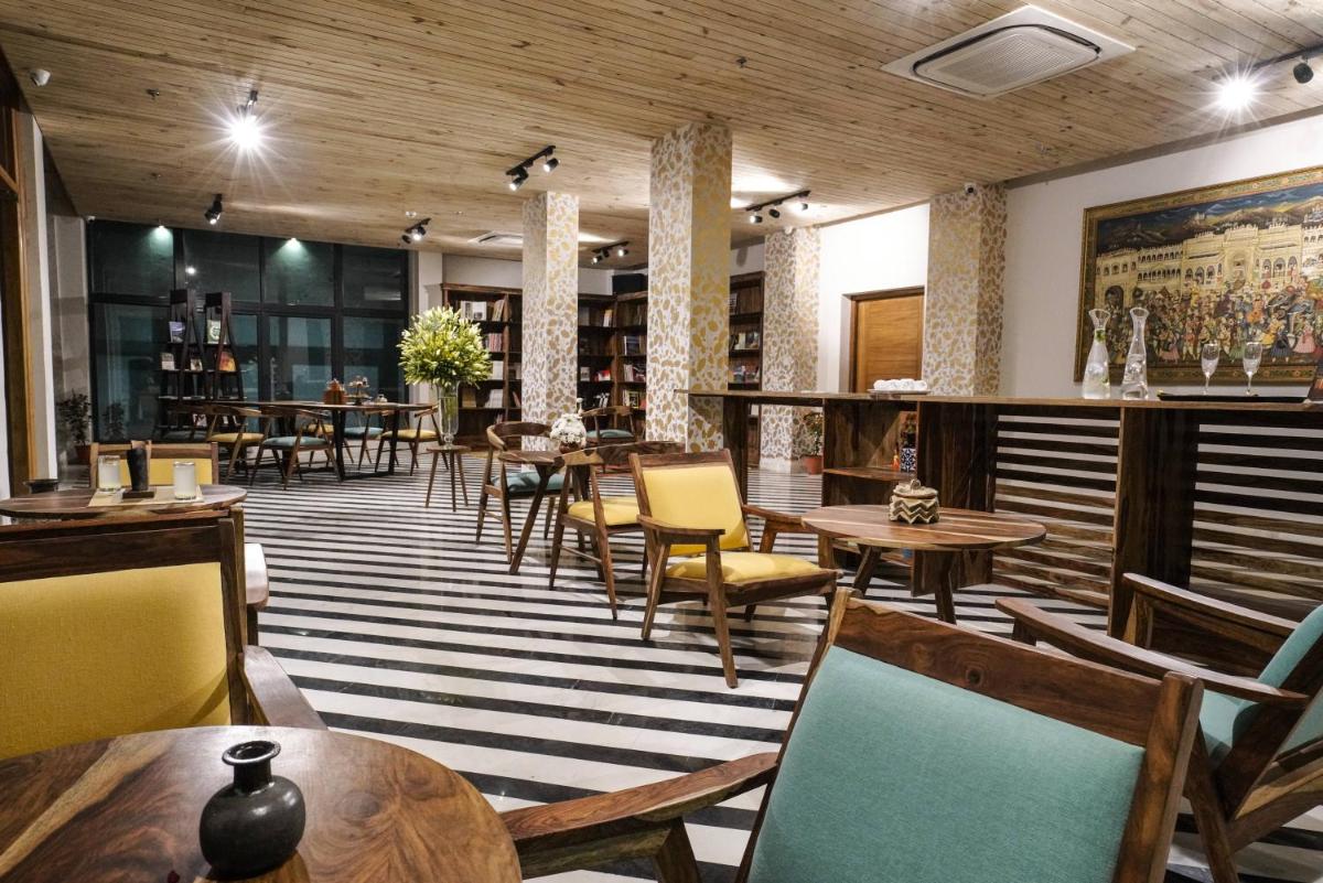 a restaurant with tables and chairs in a room at Brij Nest, Jaipur - An All Suite Boutique Hotel in Jaipur