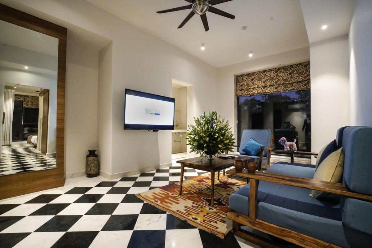 a living room with a couch and a tv at Brij Nest, Jaipur - An All Suite Boutique Hotel in Jaipur
