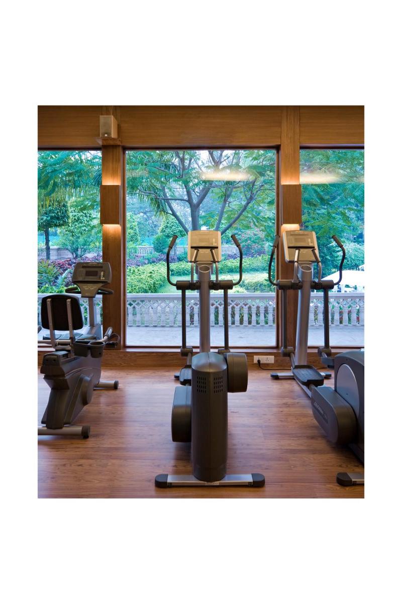 a gym with three rows of exercise bikes in front of a window at Brij Nest, Jaipur - An All Suite Boutique Hotel in Jaipur