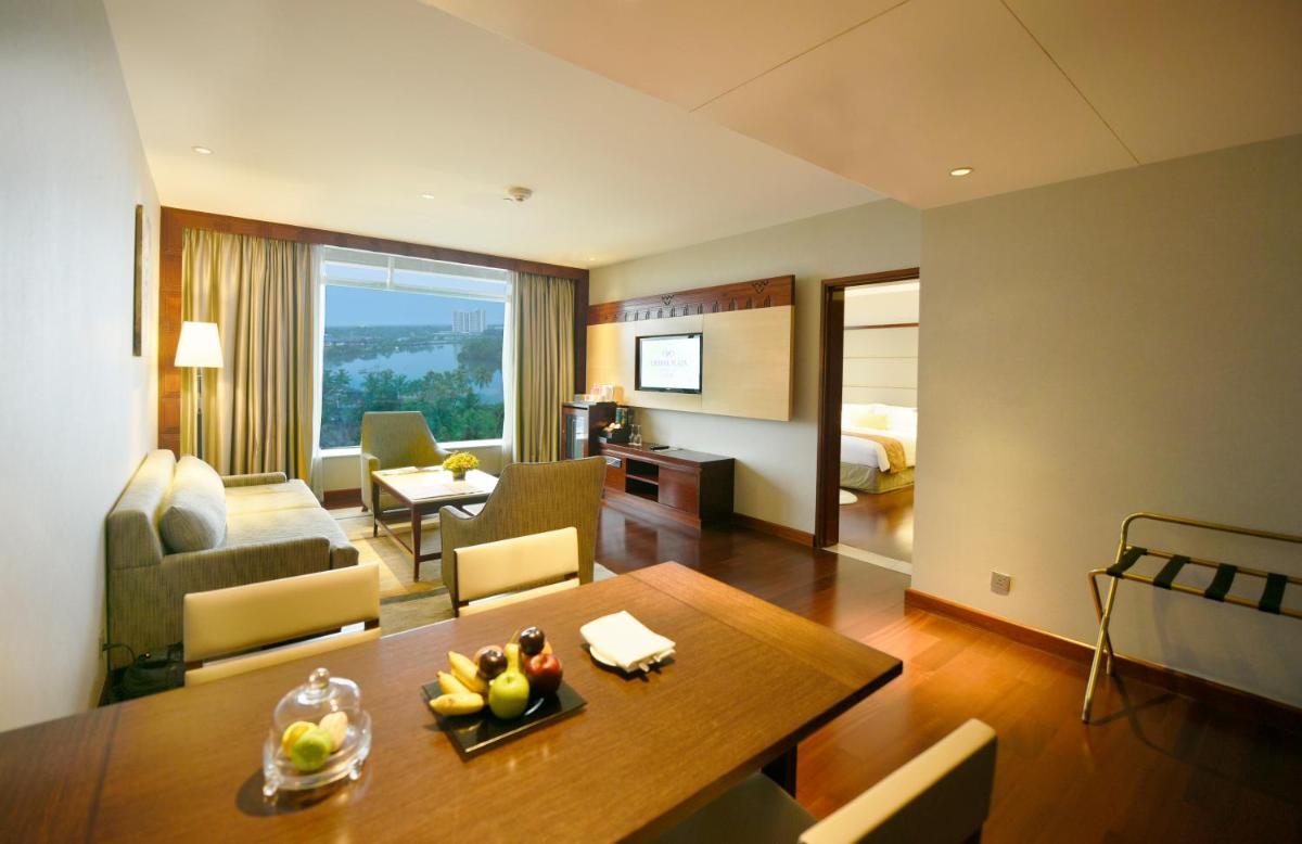 a living room with a table and a living room at Crowne Plaza Kochi by IHG in Cochin