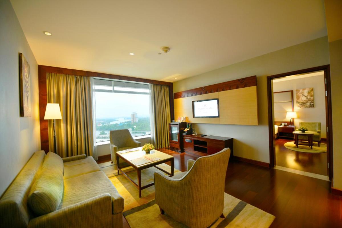 a living room with a couch and a table at Crowne Plaza Kochi by IHG in Cochin