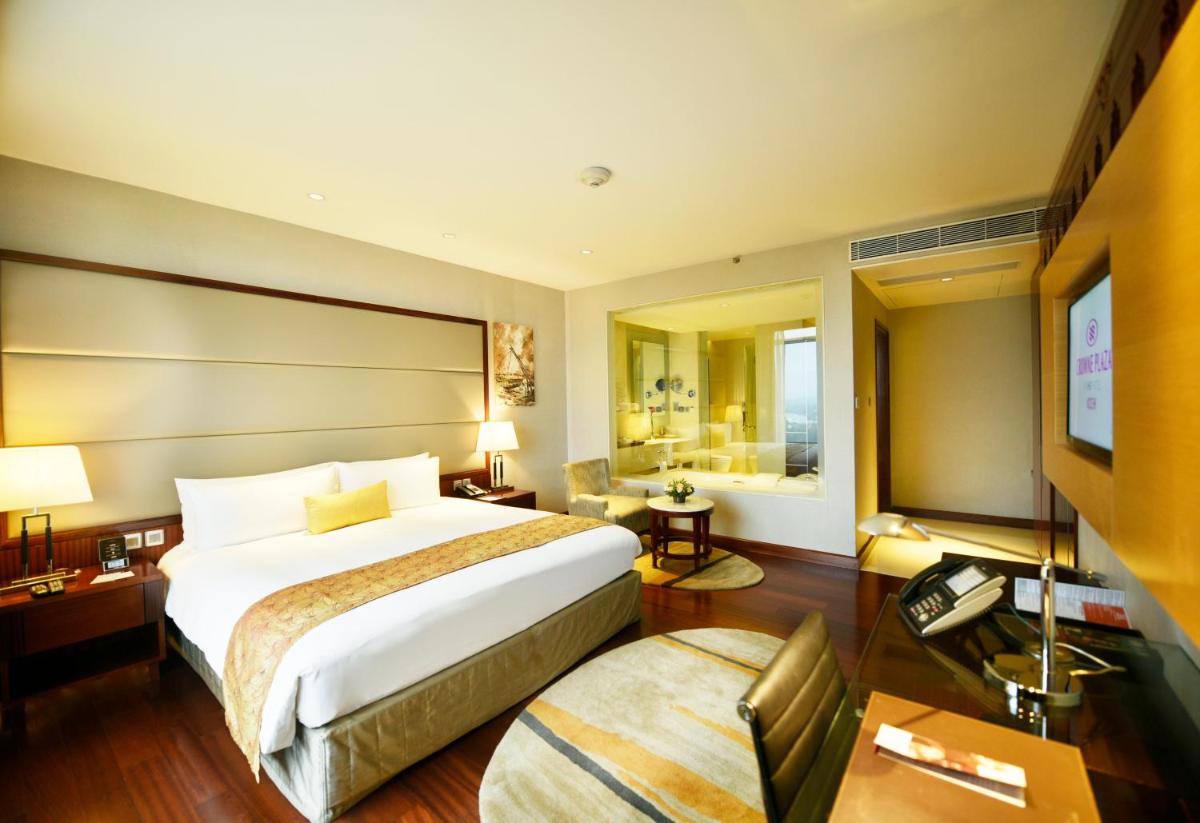 a hotel room with a bed and a television at Crowne Plaza Kochi by IHG in Cochin