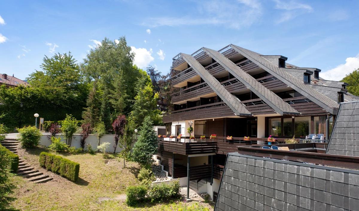 une maison avec un jardin devant dans l'établissement SOWELL HOTELS Mont Blanc et SPA, à Saint-Gervais-les-Bains