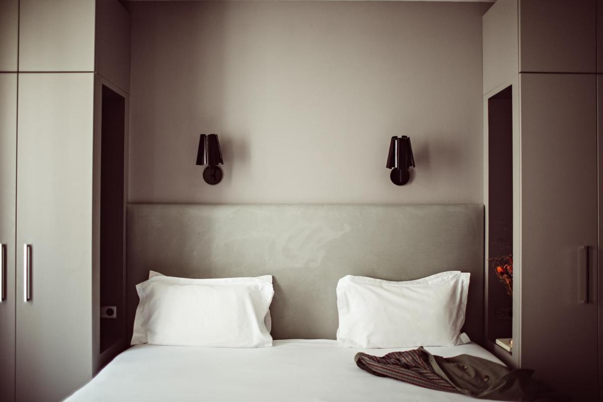 Un ou plusieurs lits dans un hébergement de l'établissement Monsieur Cadet Hotel & Spa