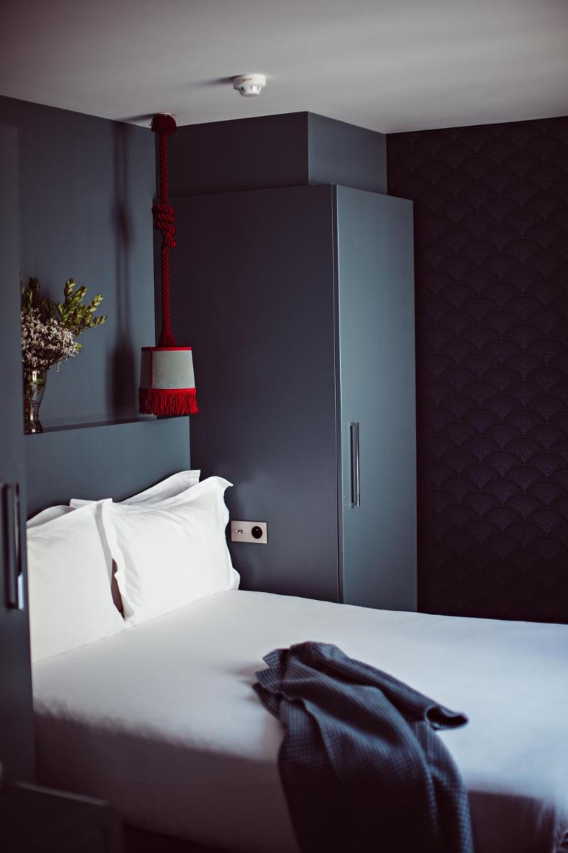 Un ou plusieurs lits dans un hébergement de l'établissement Monsieur Cadet Hotel & Spa