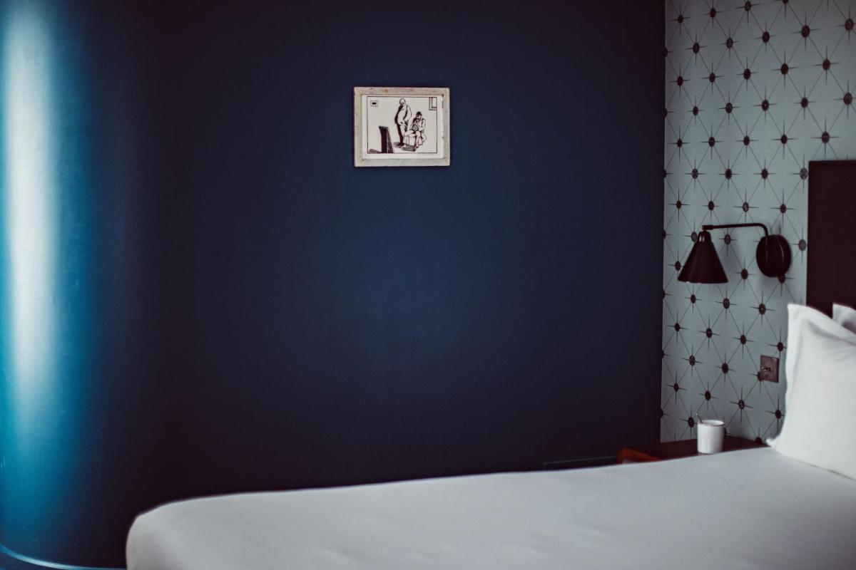 Un ou plusieurs lits dans un hébergement de l'établissement Monsieur Cadet Hotel & Spa