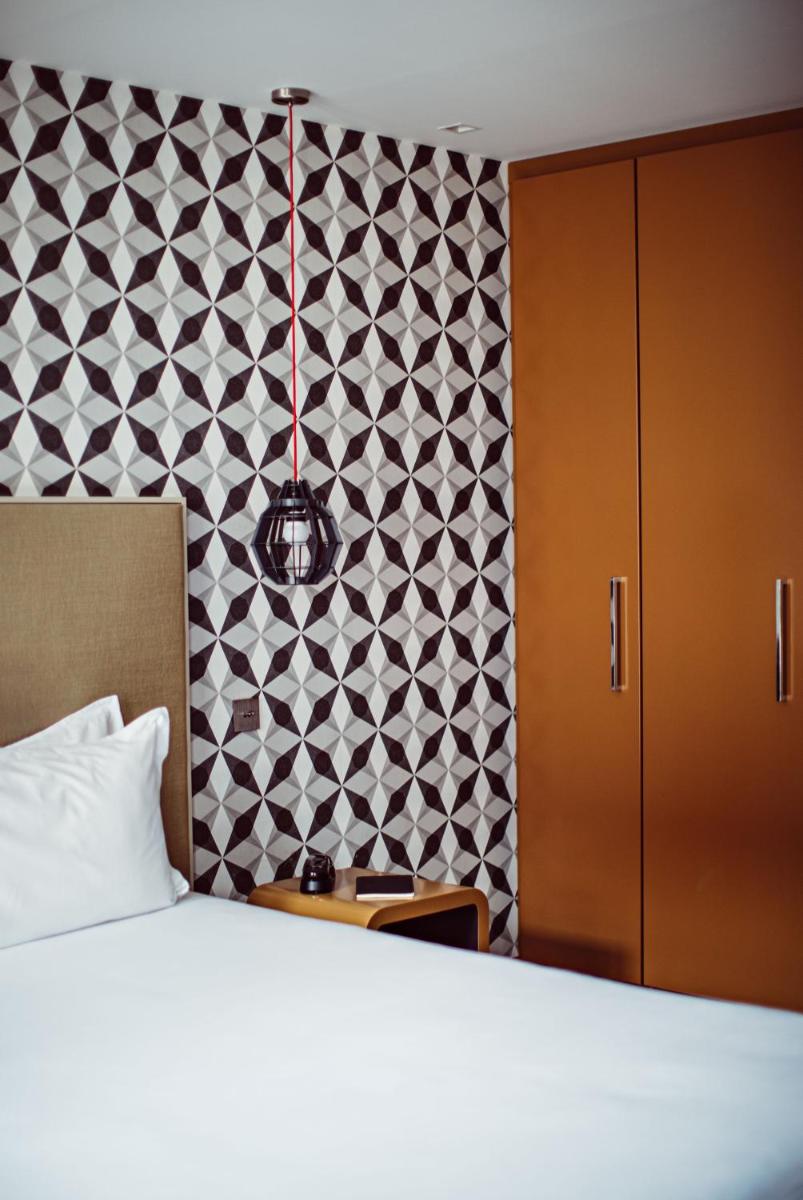 Un ou plusieurs lits dans un hébergement de l'établissement Monsieur Cadet Hotel & Spa
