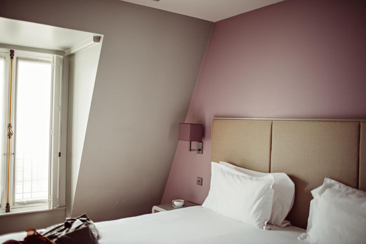 Un ou plusieurs lits dans un hébergement de l'établissement Monsieur Cadet Hotel & Spa