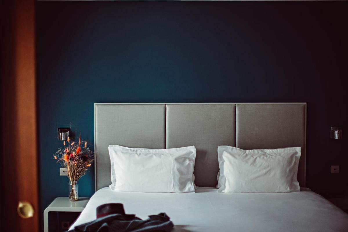 Un ou plusieurs lits dans un hébergement de l'établissement Monsieur Cadet Hotel & Spa