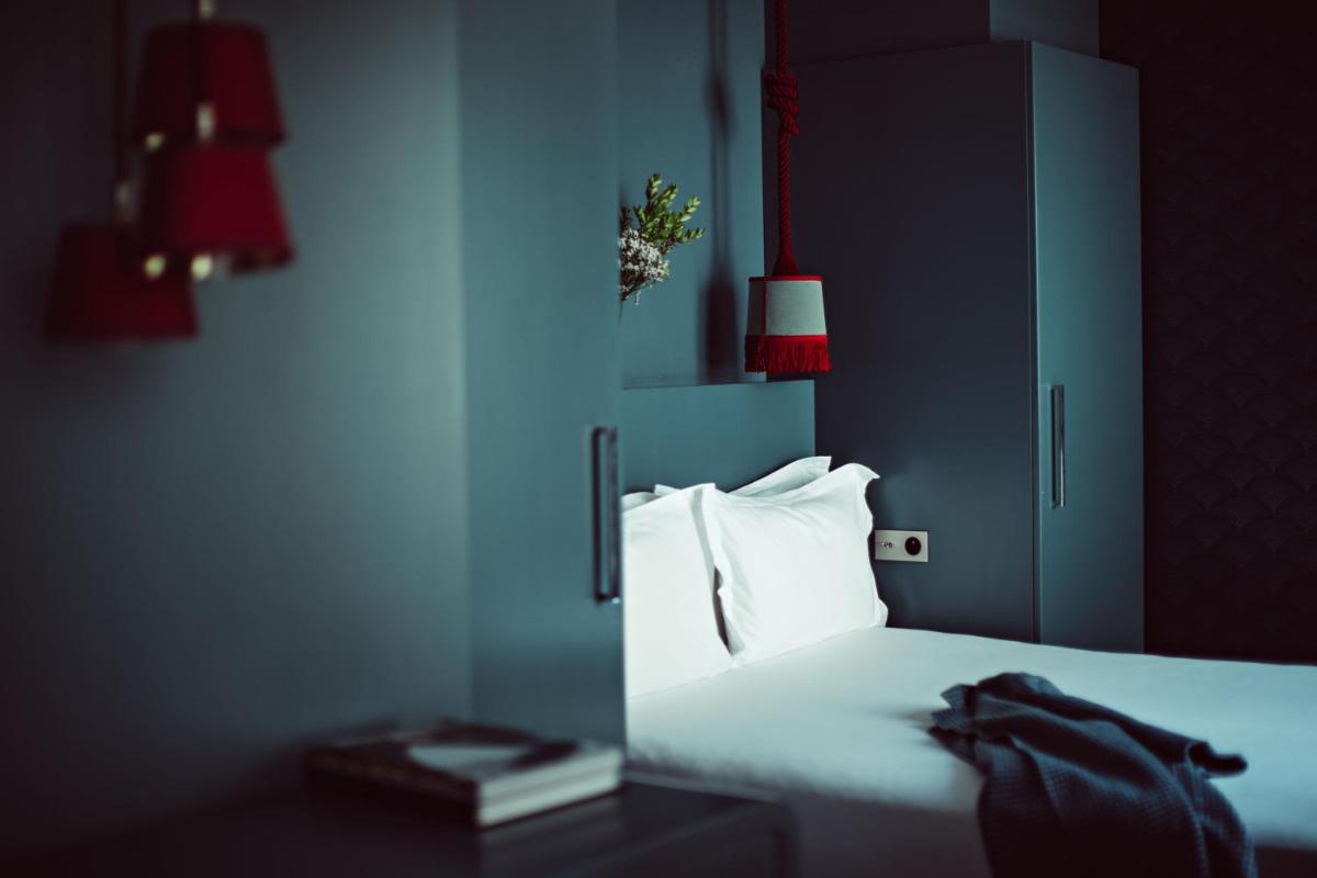 Un ou plusieurs lits dans un hébergement de l'établissement Monsieur Cadet Hotel & Spa